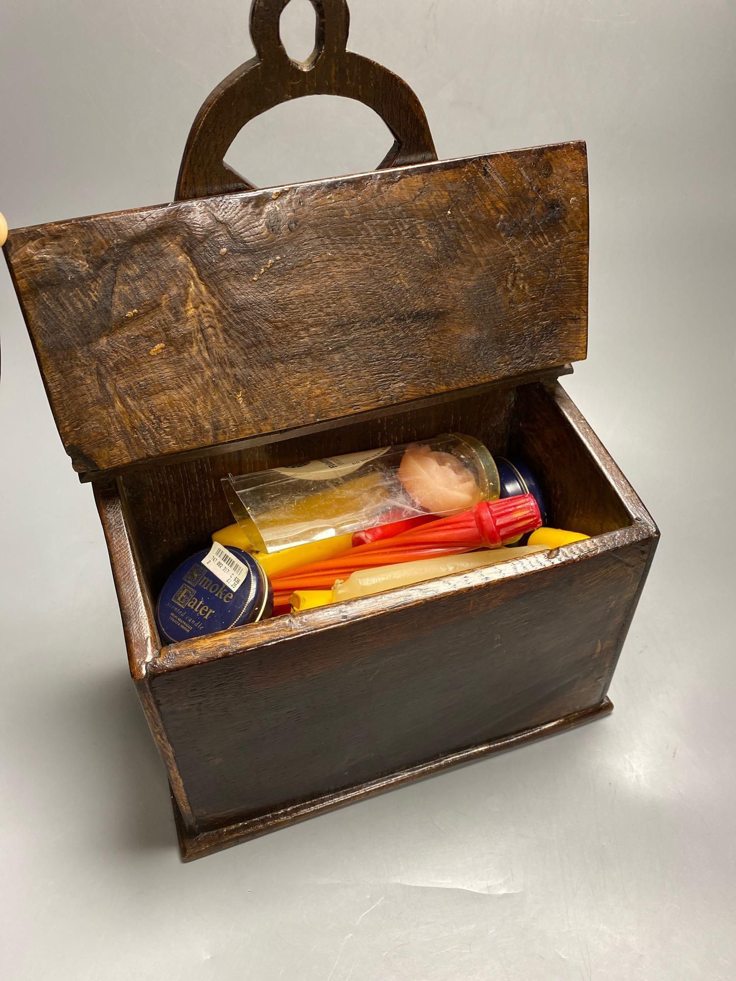 An 18th century oak candle box, cover with studded leather hinge, 28cm wide